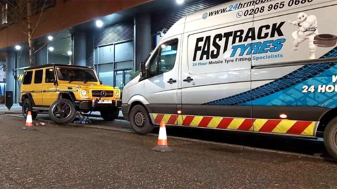 Fastrack Tyres van fitting a tyre on a London street at night