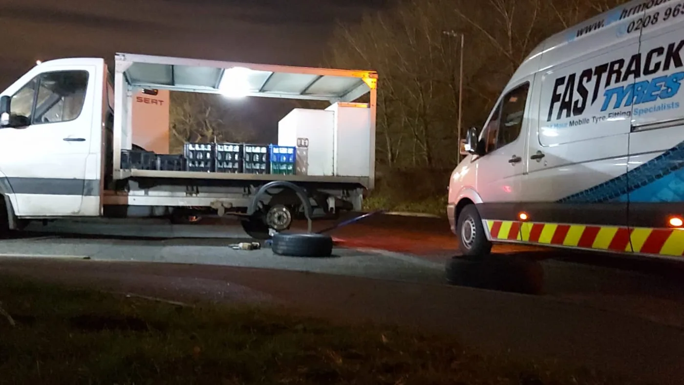 Fastrack attending a flatbed delivery truck for a night-time commercial tyre change
