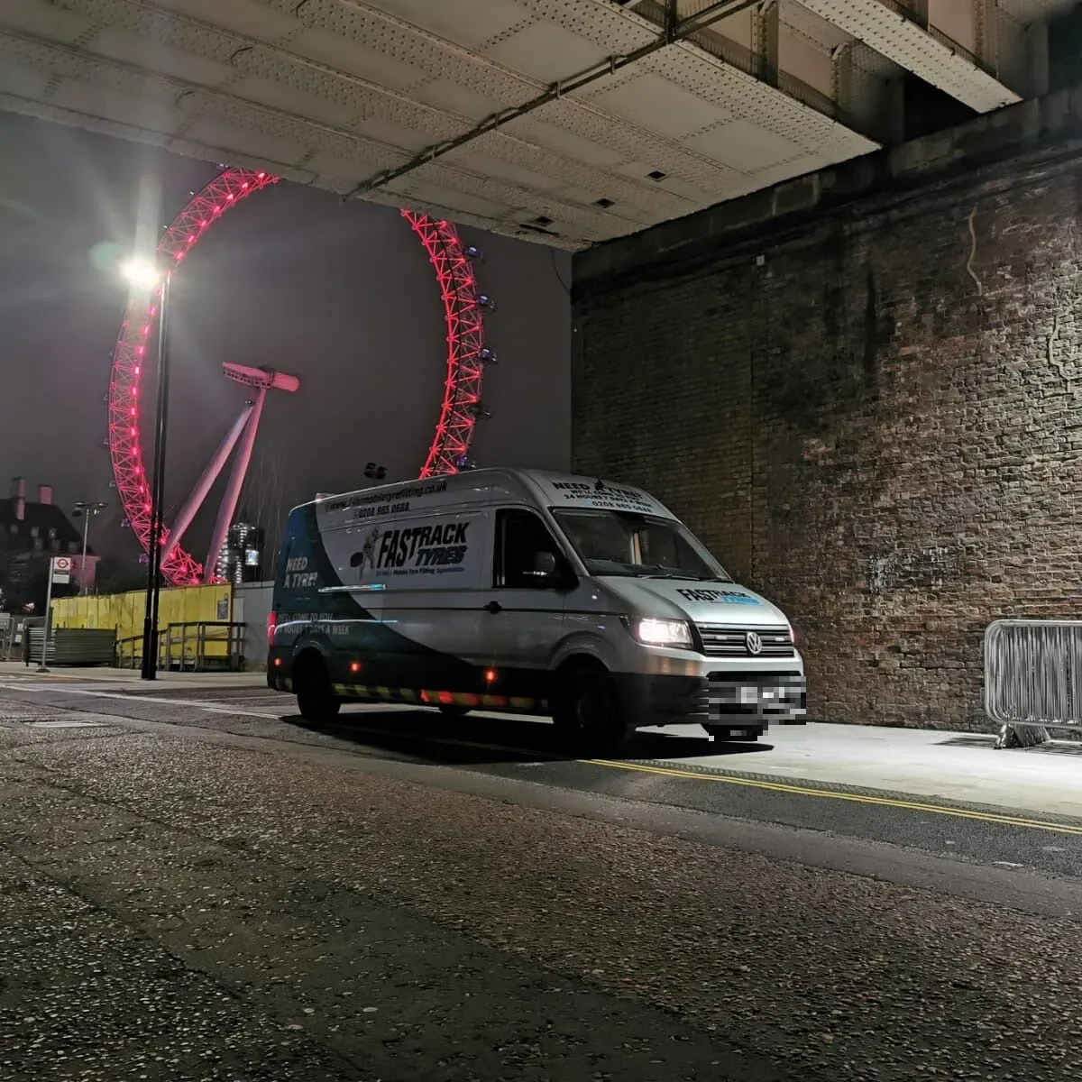 Fastrack Tyres van at night with the London Eye lit in the background