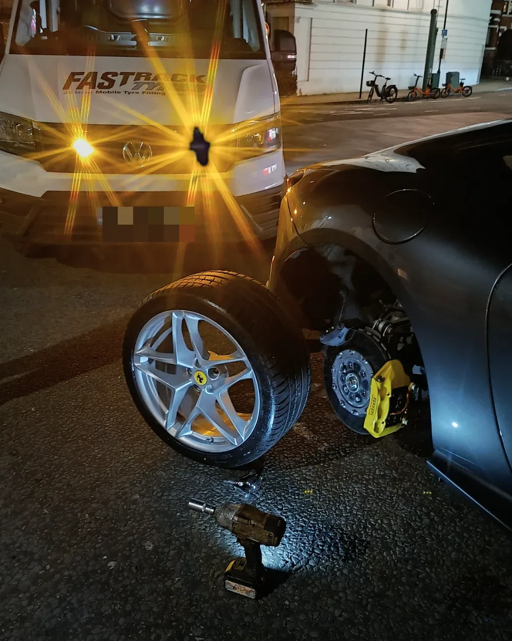 Night-time mobile tyre call-out to a Ferrari beside the Fastrack van in London