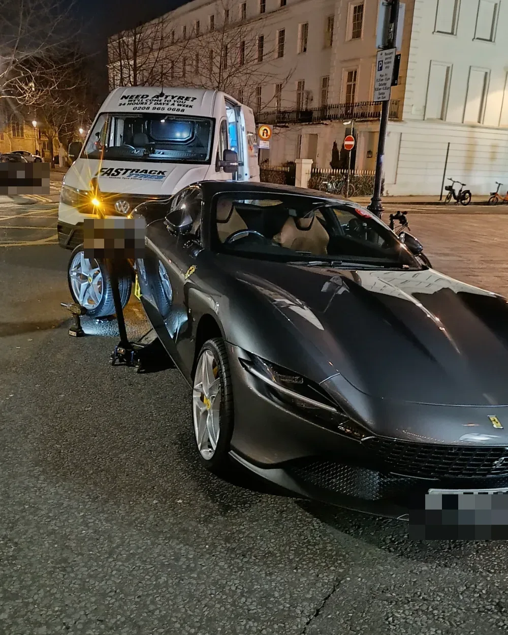 Ferrari Roma getting a night-time mobile tyre change on a London street