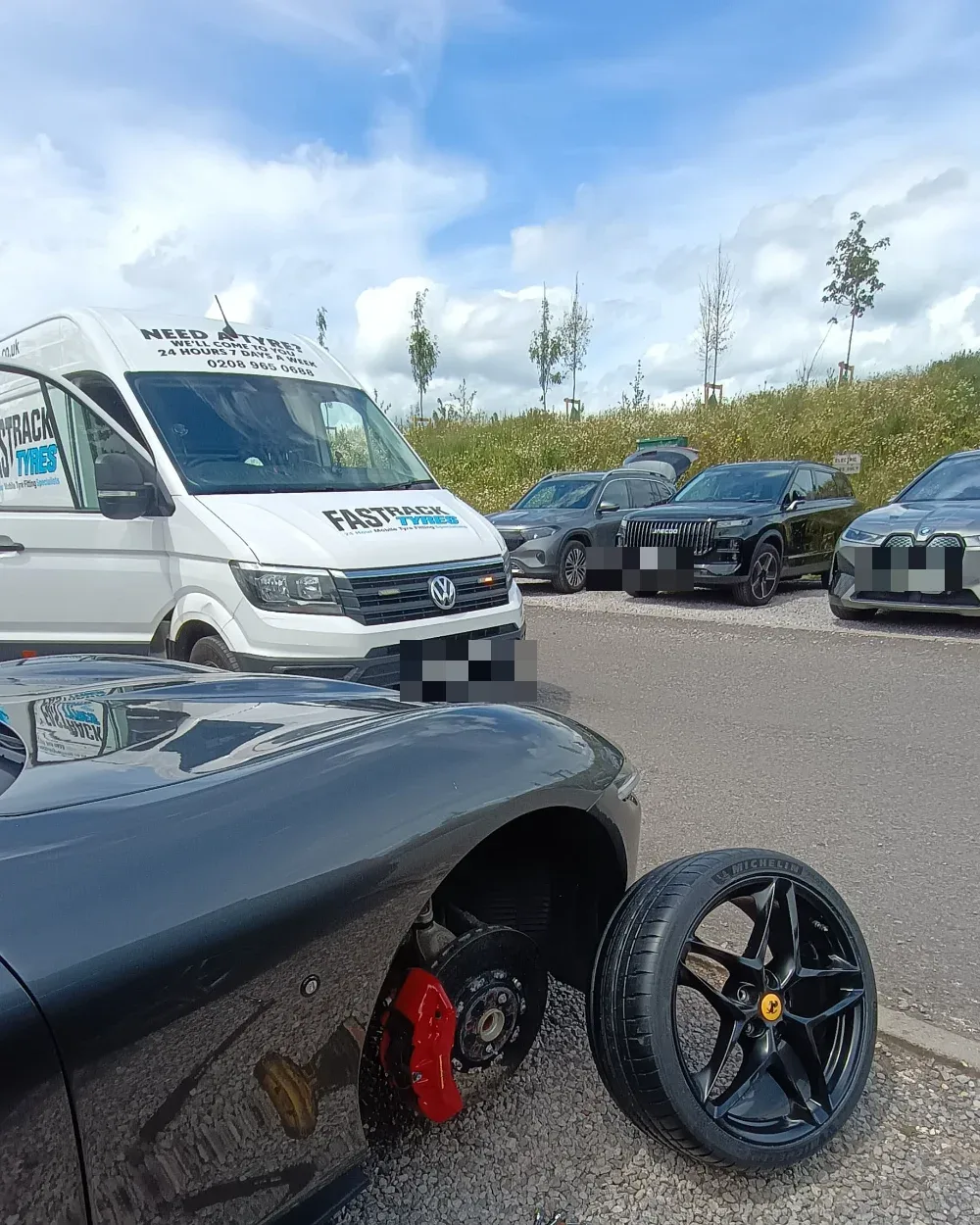 Ferrari Roma with the front wheel removed and a Michelin-shod alloy ready to fit