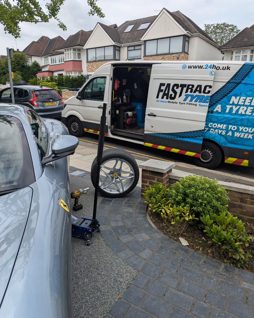 Silver Ferrari on a driveway with the Fastrack mobile tyre van and equipment