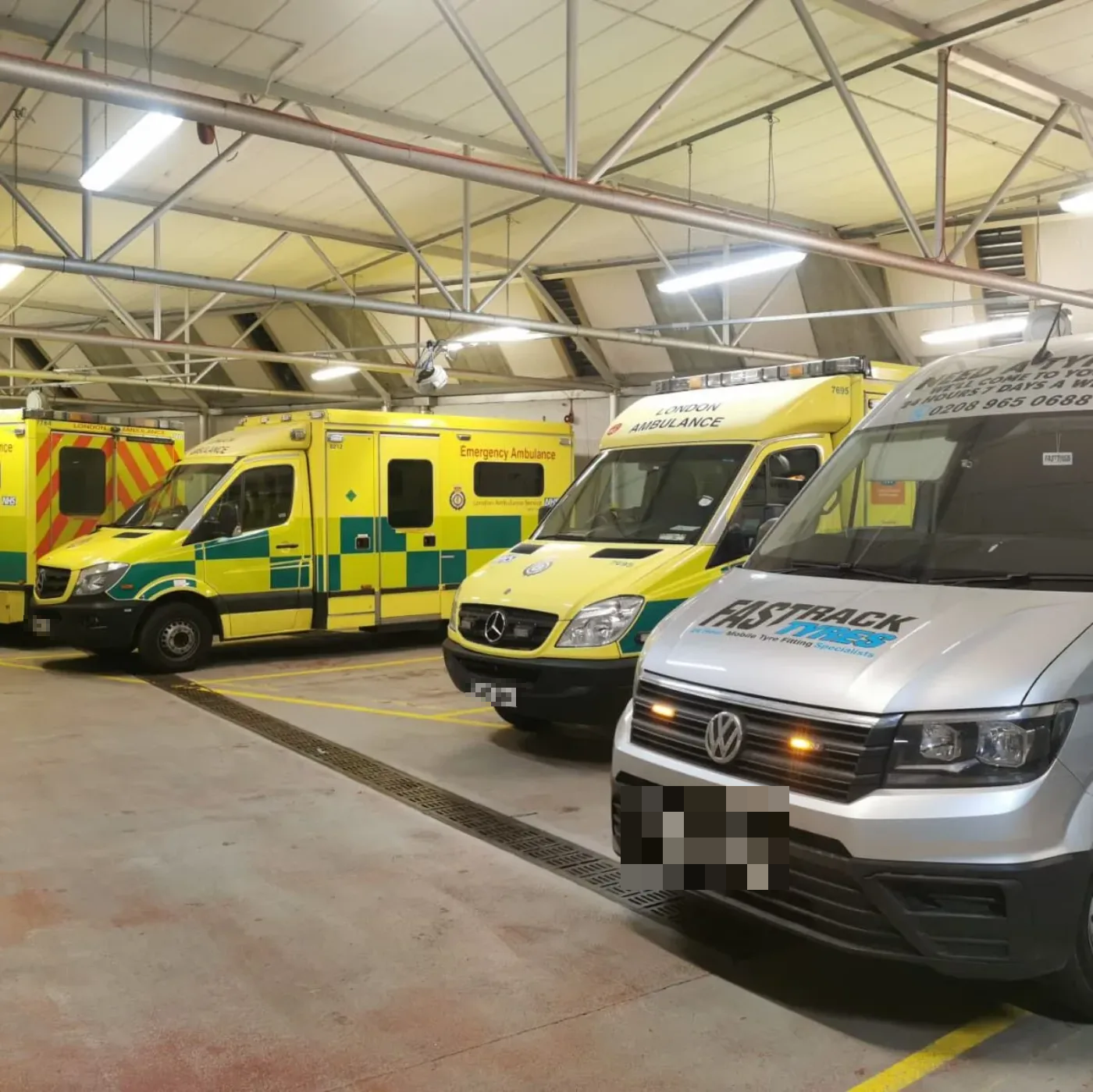 Fastrack van alongside a line of NHS ambulances at the depot