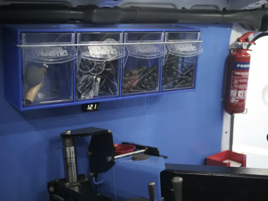 Organised valve and weight bins with fire extinguisher inside the van