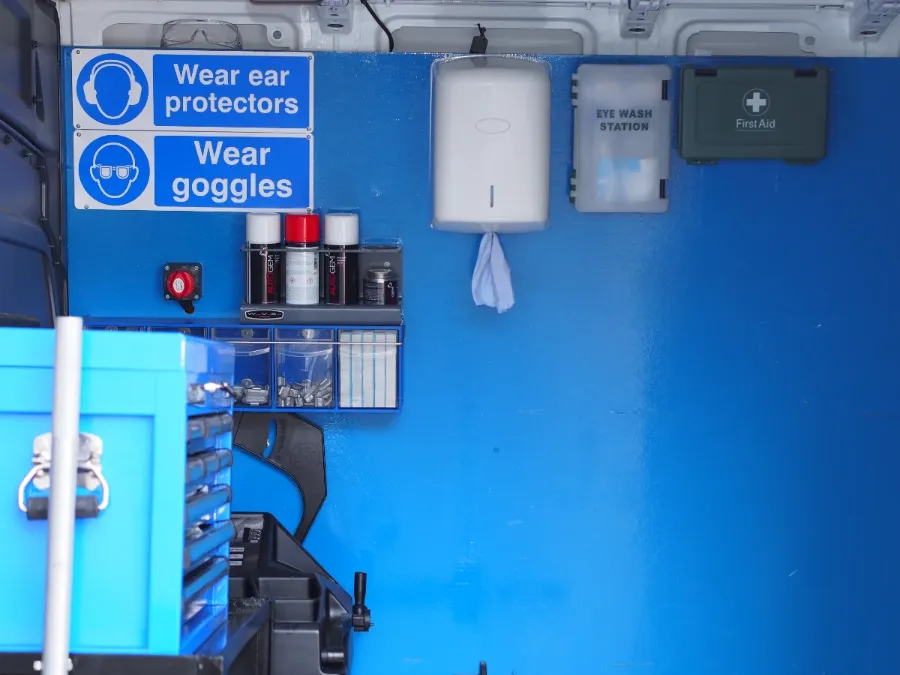 Inside a Fastrack van: safety signage, eye-wash and first-aid station