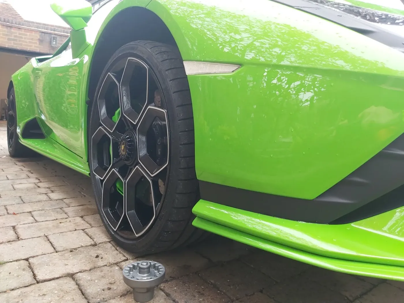 Close-up of a green Lamborghini Huracan alloy and tyre during a mobile wheel change