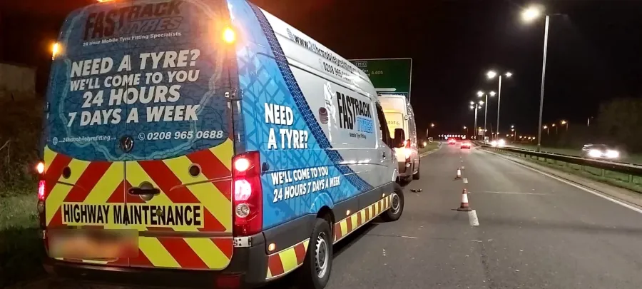 Night-time roadside tyre fitting on the M11 near London