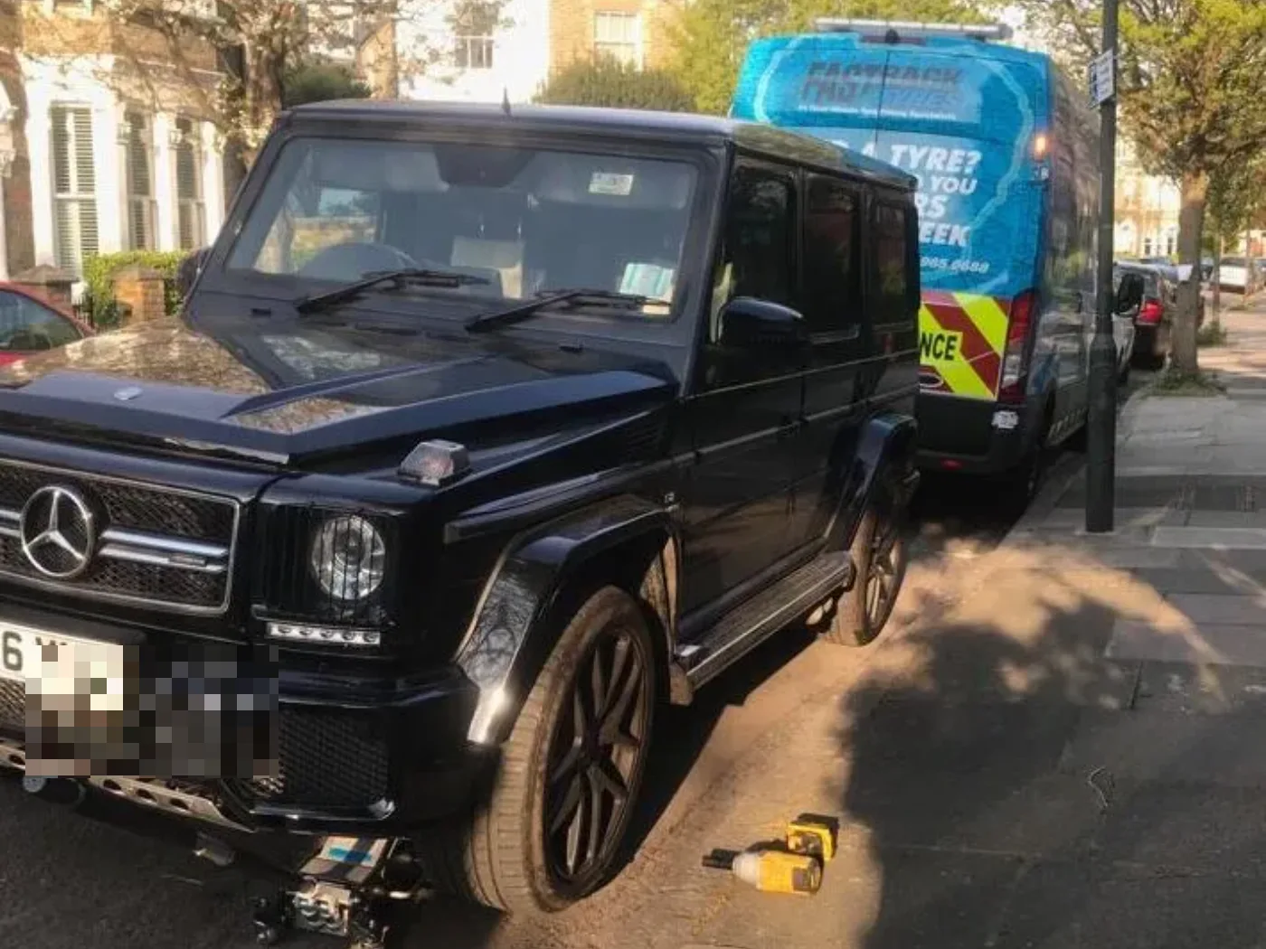 Black Mercedes-AMG G63 on a mobile tyre call-out with a traffic unit alongside