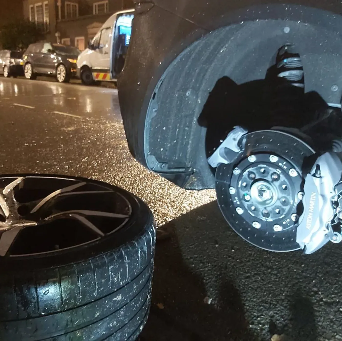 Close-up of a deflated run-flat tyre removed from the alloy during a roadside wheel change